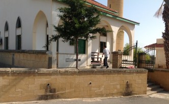 Huseyin walking towards the mosque after the call for prayer